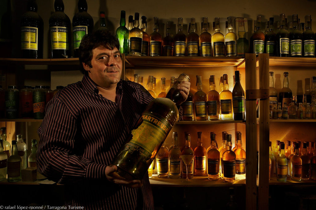 Eduard Seriol posing with a bottle of Chartreuse